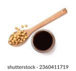 Bowl of soy sauce and spoon with soybeans isolated on white, top view