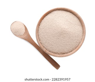 Bowl and spoon with active dry yeast isolated on white, top view