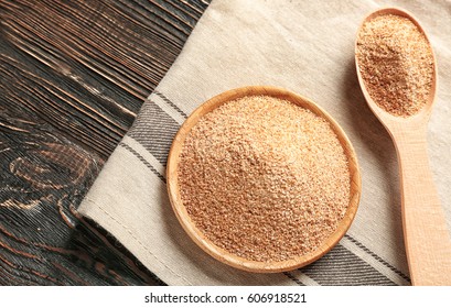 Bowl and spoon with bread crumbs on napkin