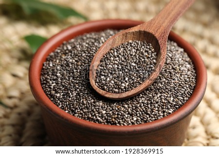 Bowl and spoon with chia seeds, closeup