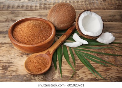 Bowl And Spoon Of Coconut Sugar On Wooden Background