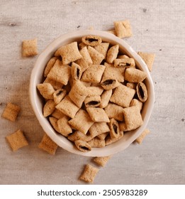 Bowl with squared cereal filled with chocolate on a gray wooden table. - Powered by Shutterstock