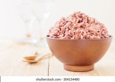 Bowl Of Steamed Brown Rice On Wood Table