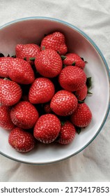 a bowl of strawberries for breakfast in the morning. Harvest from lembang, Bandung, Indonesia. its large size with a sweet taste is suitable mixed with oatmeal, pancakes or eaten directly.