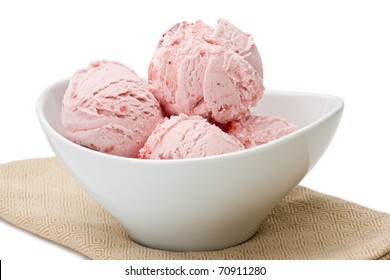A bowl of strawberry ice cream on napkin.