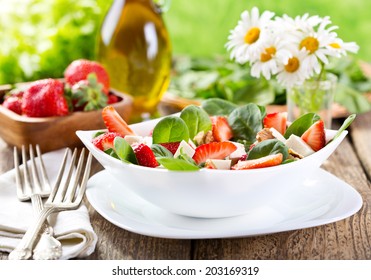 Bowl Of Strawberry Salad On Wooden Table