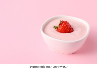 Bowl Of Strawberry Yogurt On Color Background