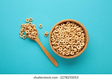 Bowl of sugar-coated corn flakes and spoon on blue background. Top view - Powered by Shutterstock