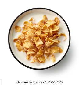 bowl of sweet cornflakes with milk isolated on white background, top view