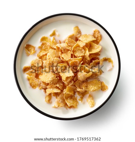 bowl of sweet cornflakes with milk isolated on white background, top view