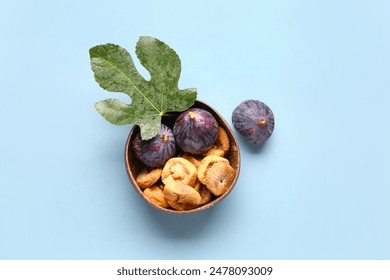 Bowl with sweet dried figs and fresh fruits on blue background - Powered by Shutterstock