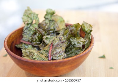 Bowl of swiss chard chips with Olive oil and sea salt