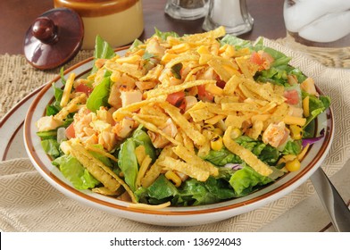 A Bowl Of Taco Salad With Chicken And Cheese