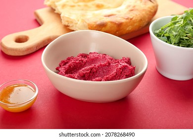 Bowl With Tasty Beet Hummus, Sauce, Fresh Sprouts And Pita Bread On Color Background