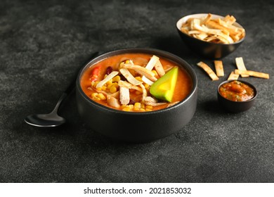 Bowl Of Tasty Chicken Enchilada Soup On Dark Background