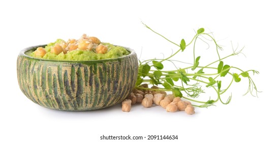 Bowl with tasty green pea hummus on white background