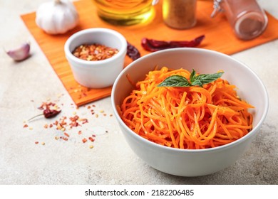 Bowl Of Tasty Korean Carrot Salad On Light Background