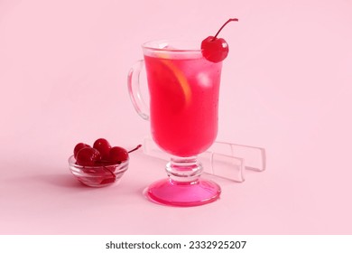 Bowl of tasty maraschino cherries and glass cup with cold cocktail on pink background