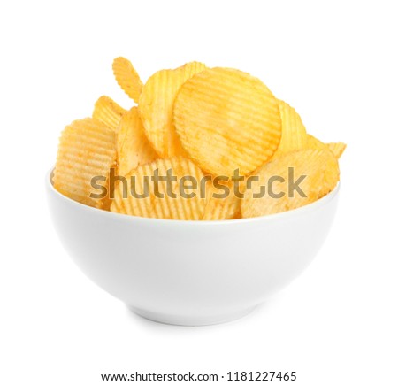 Bowl of tasty ridged potato chips on white background