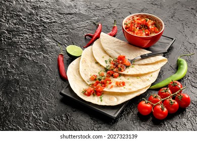 Bowl Of Tasty Salsa Sauce With Tortilla On Dark Background