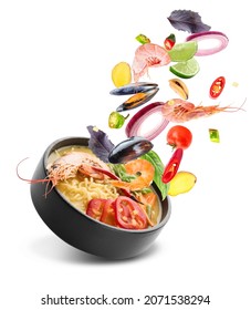 Bowl Of Tasty Thai Soup With Flying Ingredients On White Background