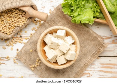 Bowl with tasty tofu cheese on table - Shutterstock ID 1703510929
