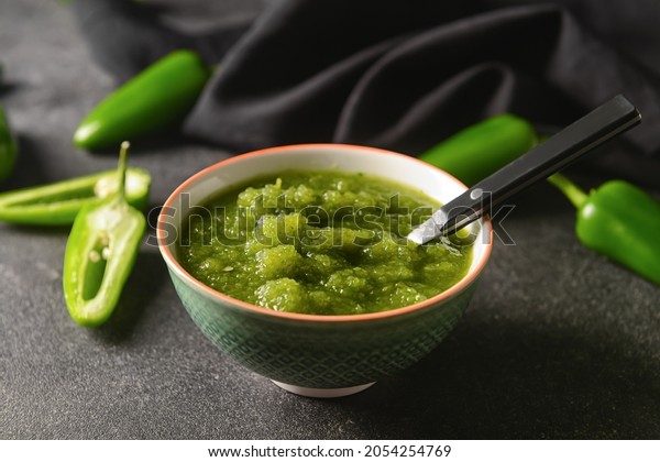 Bowl of\
Tomatillo Salsa Verde sauce on dark\
background