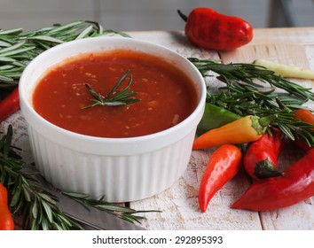 Bowl Of Tomato Hot Sauce With Peppers, Rosemary And Cutlery