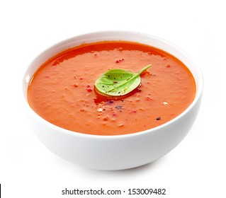 Bowl of tomato soup isolated on a white background