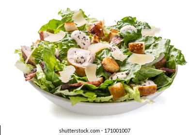 Bowl Of Traditional Caesar Salad With Chicken And Bacon Isolated On White Background