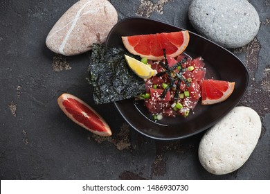 Bowl With Tuna Ceviche In Grapefruit Juice, Above View On A Brown Stone Background With Pebble Stones