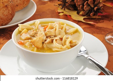 A Bowl Of Turkey Noodle Soup On A Thanksgiving Table