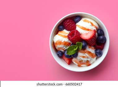 Bowl Of Vanilla Ice Cream With Fresh Berries Isolated On Pink Background. Top View