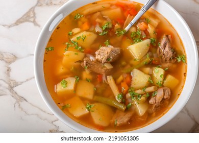 Bowl Of Vegetable Beef Soup And One Spoon