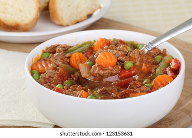 Bowl Of Vegetable Beef Soup With Spoonful Of Soup