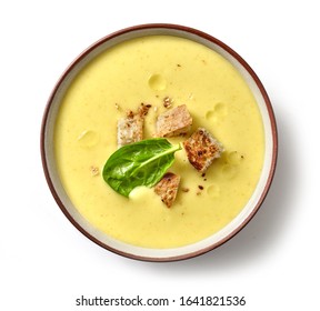 bowl of vegetable cream soup isolated on white background, top view