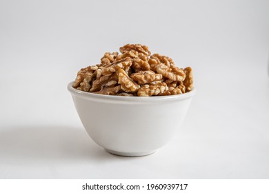 Bowl with walnuts on white background - Powered by Shutterstock