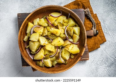 Bowl of warm potato salad with bacon, German Kartoffelsalat. White background. Top view. - Shutterstock ID 2225591149