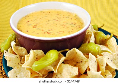 Bowl Of Warm Queso (cheese Dip) With A Plate Of Tortilla Chips