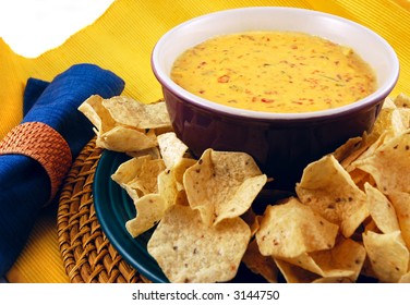 Bowl Of Warm Queso (cheese Dip) With A Plate Of Tortilla Chips