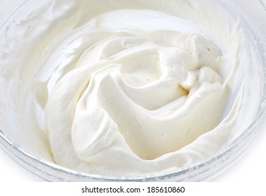 bowl of whipped cream on a white background