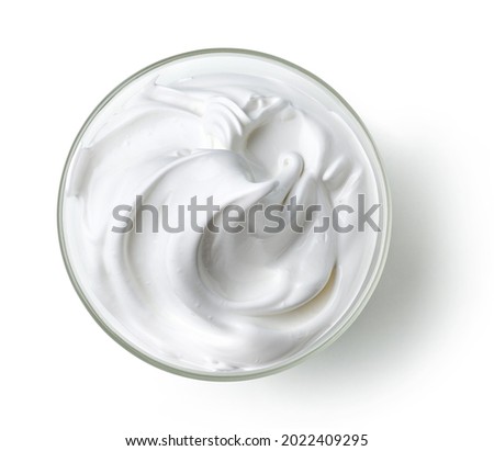 bowl of whipped egg whites and sugar cream isolated on white background, top view