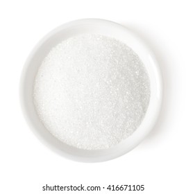 Bowl of white sugar isolated on white background, top view
