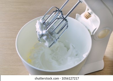 Bowl with wipped cream and electric mixer