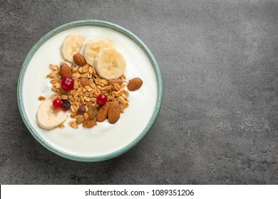 Bowl With Yogurt, Banana And Granola On Table, Top View