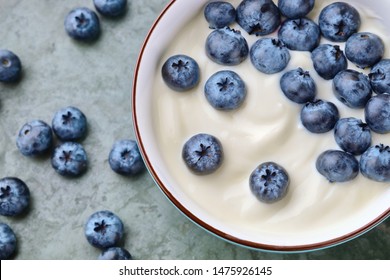 Bowl With Yogurt And Blueberries On Table, Top View