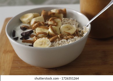 Bowl Of Yogurt With Oatmeal, Chocolate, Banana And Peanut Butter