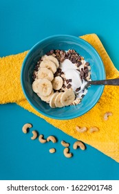 Bowl With Yummy Muesli, Yogurt And Banana Breakfast. Healthy Vegan Food Concept. Top Down View. Flat Lay. Vertical Design.