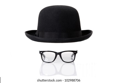 Bowler hat and glasses against white