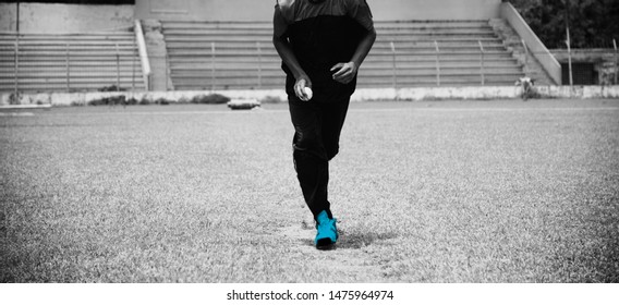 A bowler is running in a field to deliver a cricket ball - Powered by Shutterstock